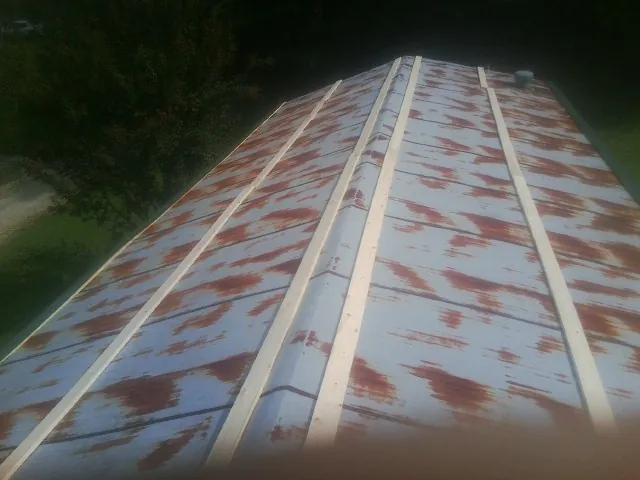 Rusted metal roof panels with new wood purlins before replacement — Storm Damage Roof Repair in Wading River by Roofing Brothers
